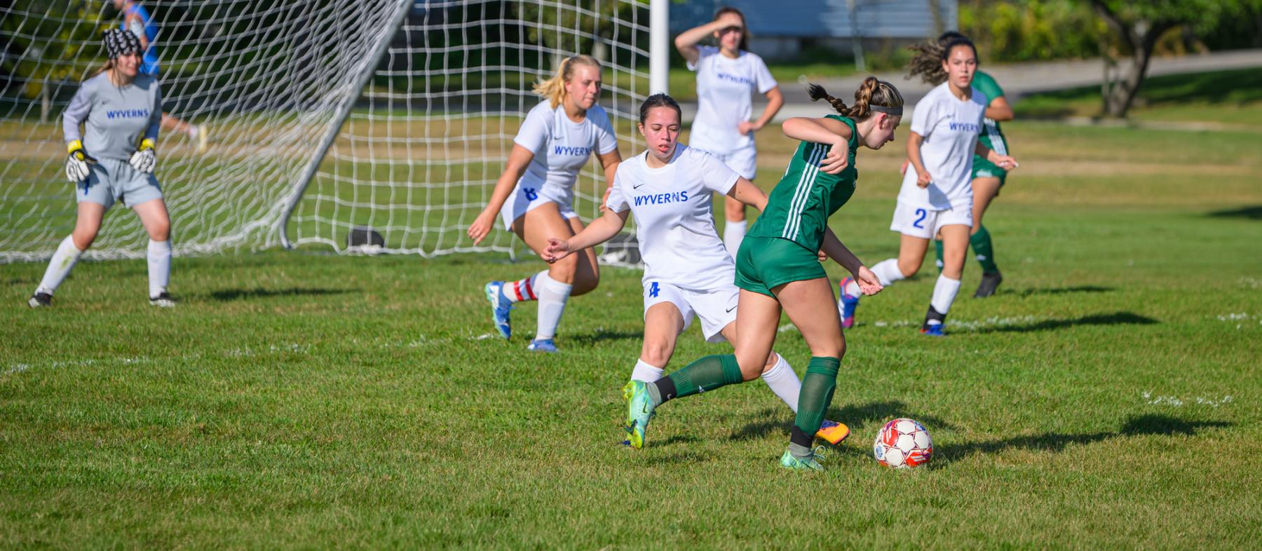QCC soccer players at a game