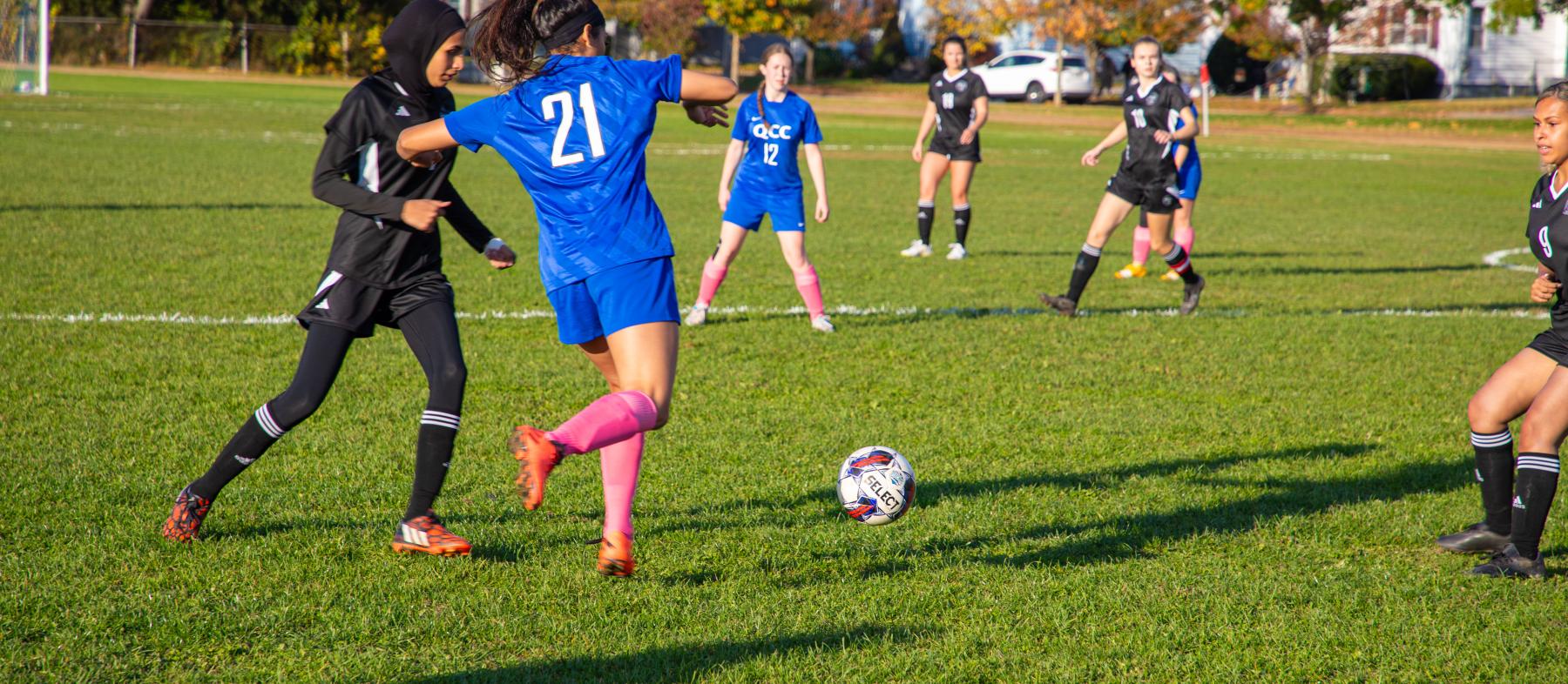 QCC soccer players at a game