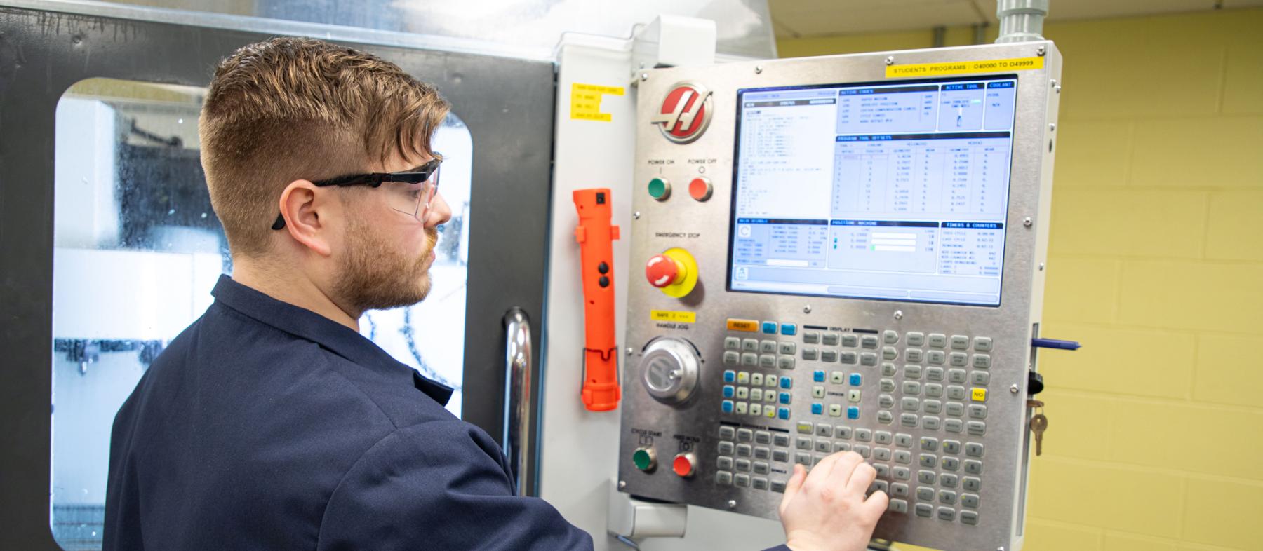 A student working with a machine