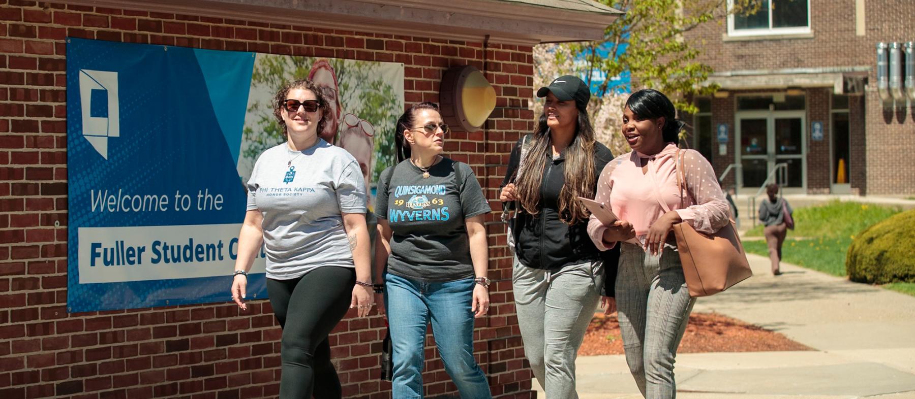 QCC students in front of the fuller student center.