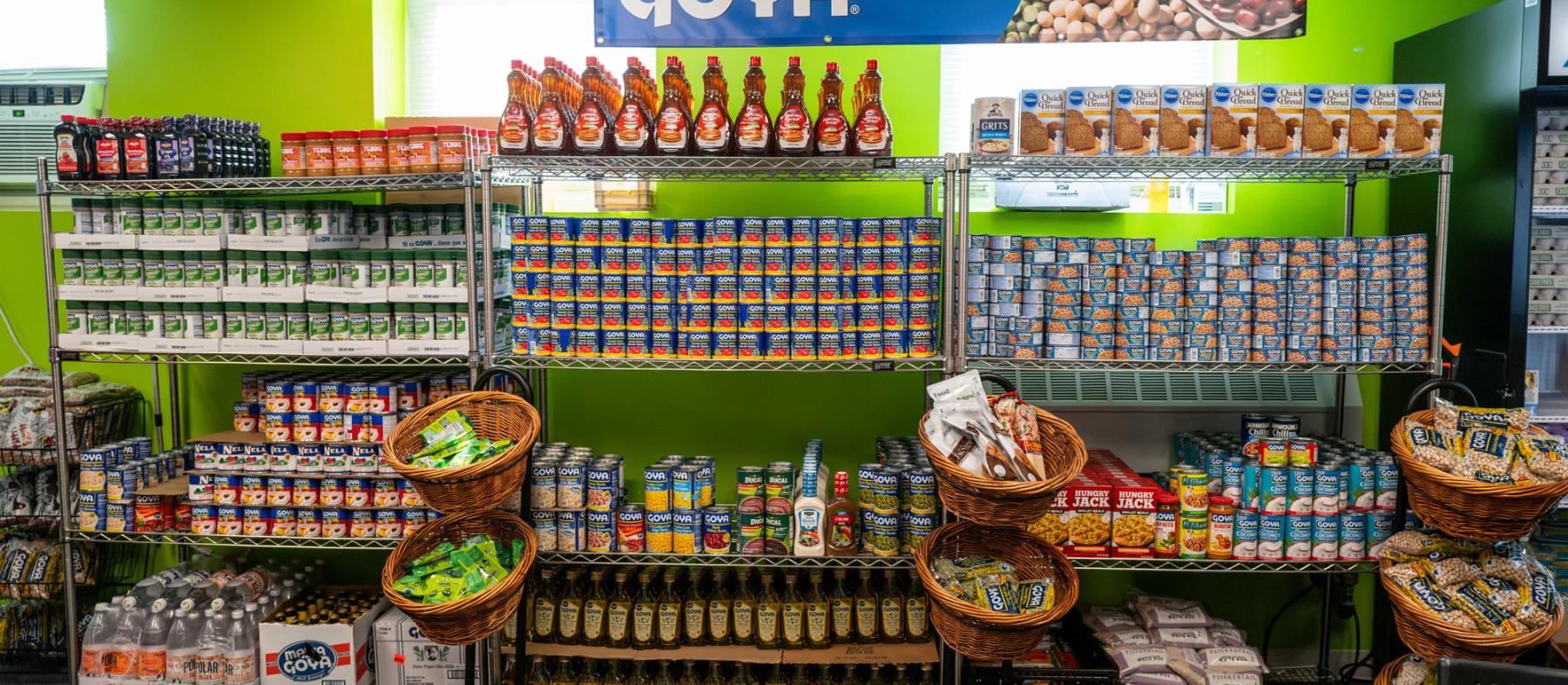 Shelves filled with Goya products at the QCC Homeplate Food Pantry
