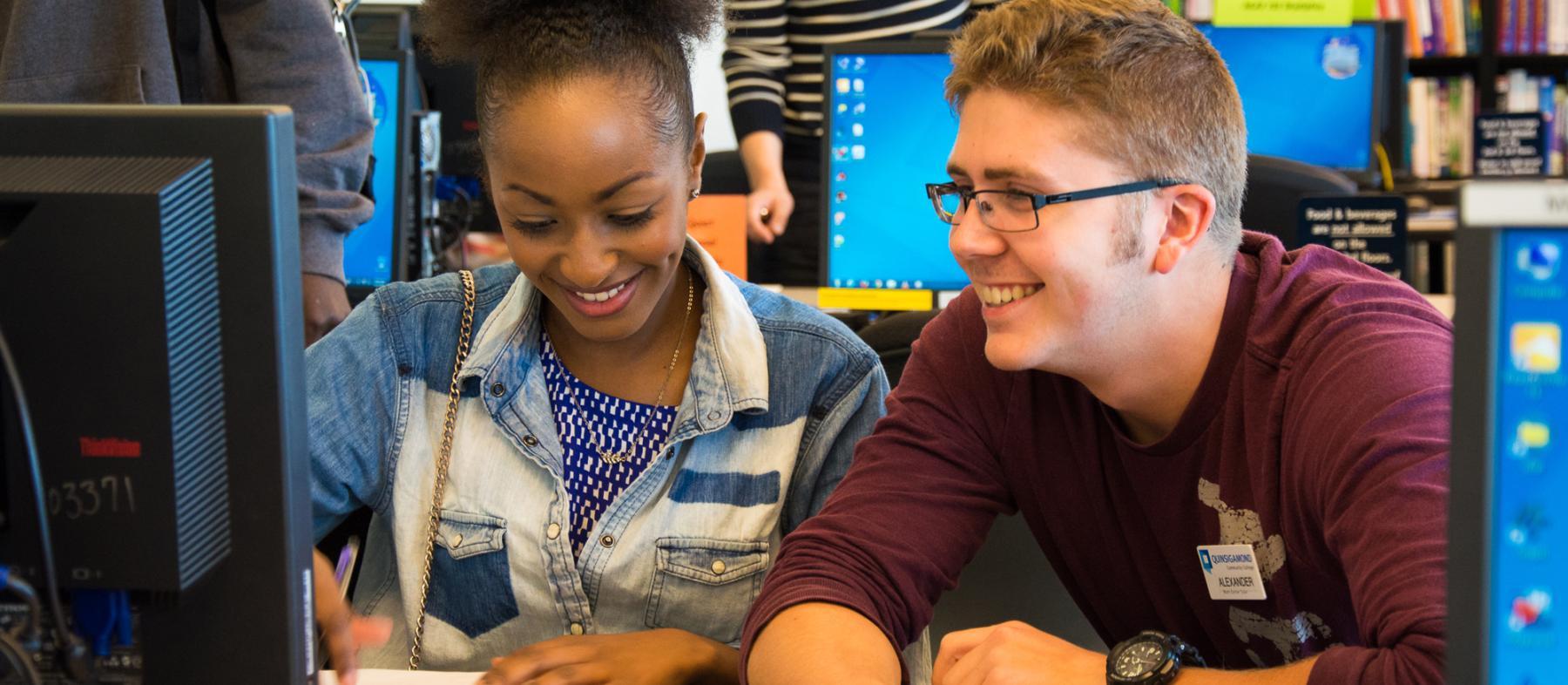 Student and tutor working on a computer