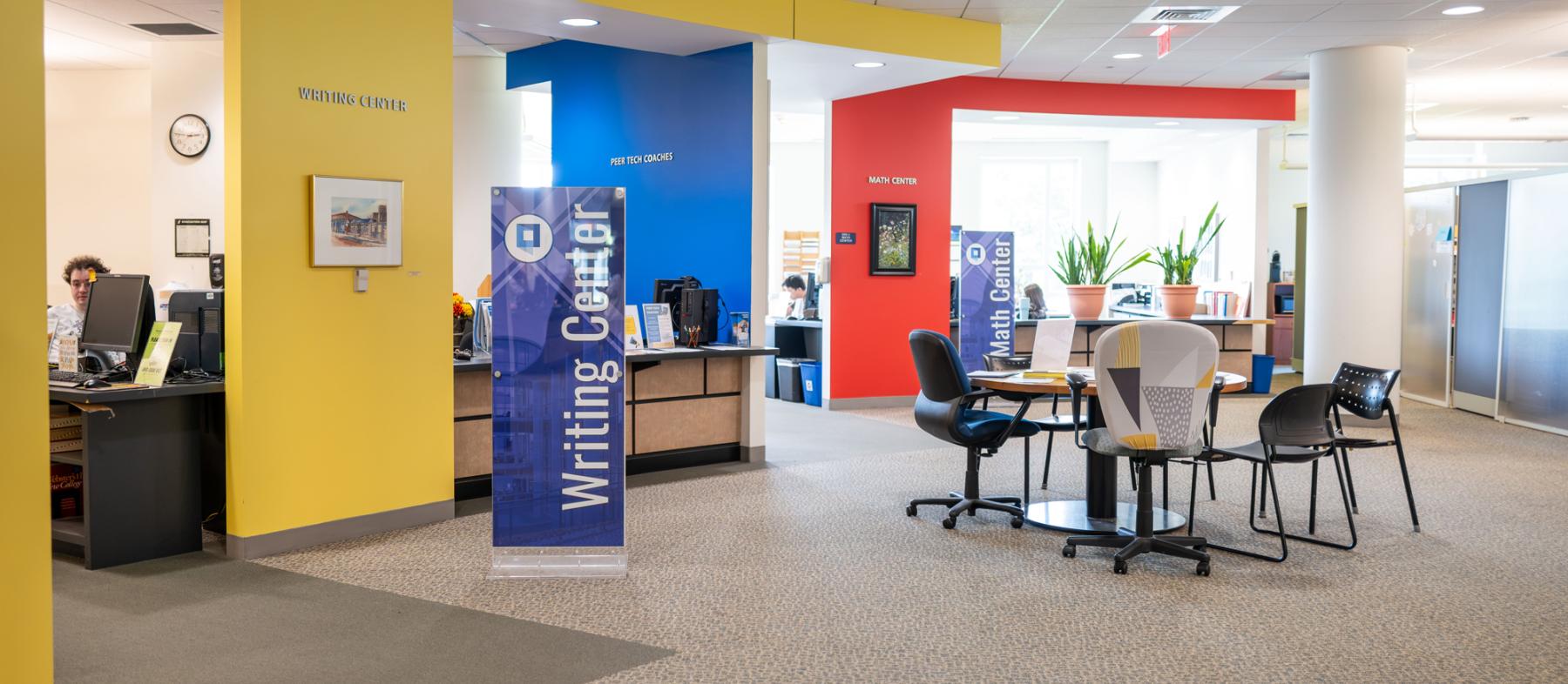 The room that houses the tutoring centers with front desk and tables and chairs