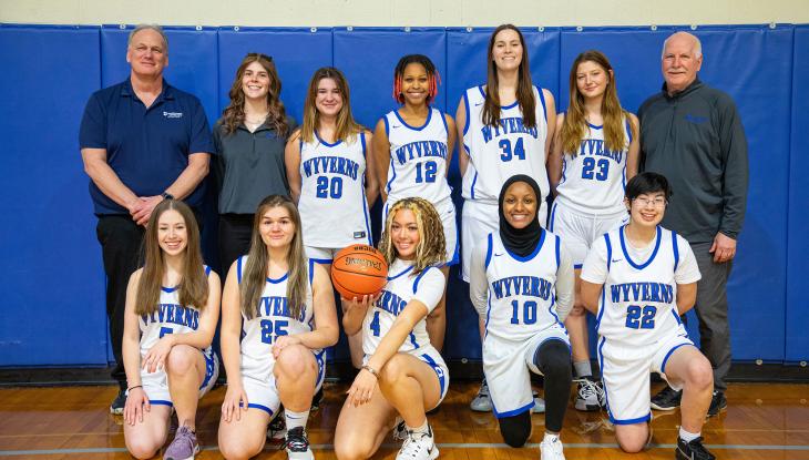 The Women's Basketball team with coaches Rich Small (left, back row) and James Griffin (right, back row)