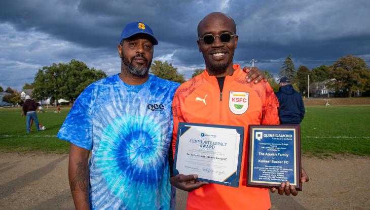 QCC Director of Community Engagement Sean Harris (left) and Kwame Appiah of Kumasi FC Soccer Club