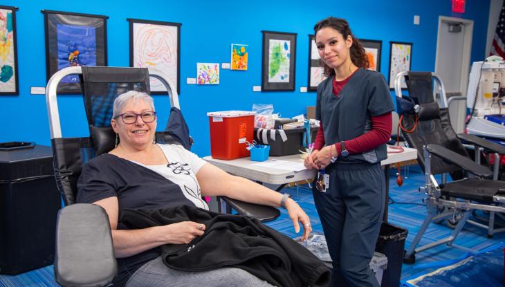 Assistant Director of Operations for External Affairs Shirley Dempsey (left) donating blood.
