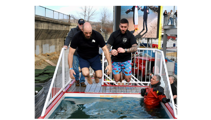 Community Resource Officer Nick Yacuzzi takes the Polar Plunge with a friend.