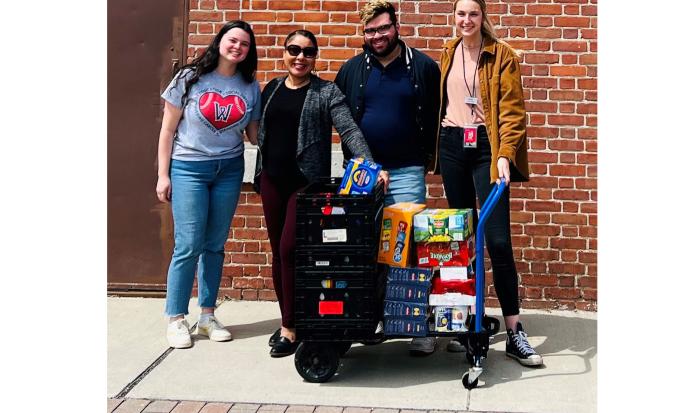 Hilda Maldonado (second from left), program director at Green Island Neighborhood Center with WooSox representatives. Hilda Maldonado (second from left), program director at Green Island Neighborhood Center with WooSox representatives.