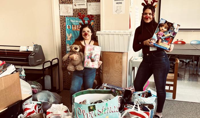 From left: Southbridge Elementary School liaisons Karina Alvarado and Selena Robles with donations from QCC's Human Services Clu From left: Southbridge Elementary School liaisons Karina Alvarado and Selena Robles with donations from QCC's Human Services Clu