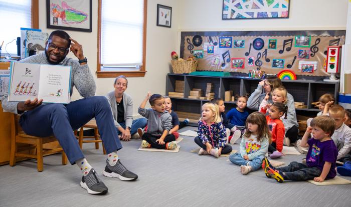 Executive Director of Diversity, Equity & Inclusion Kevin Lovaincy reads to children. Executive Director of Diversity, Equity & Inclusion Kevin Lovaincy reads to children.