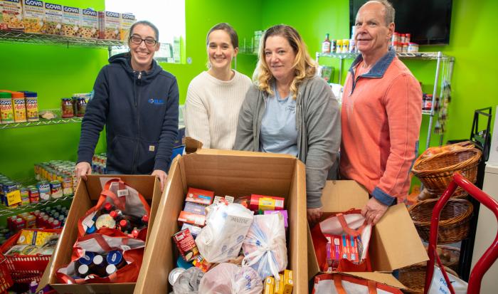 From left: Jodie Bastarache from Elm Electrical, food pantry staff members Julia Rooney and Cheryl Marrino, and Mark Laverdure, who drives the truck for the food pantry