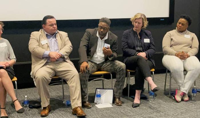 Director of Community Engagement Sean Harris (center) speaks at the Housing Justice Summit