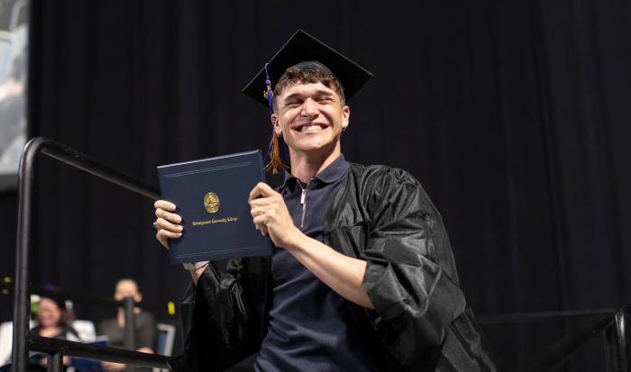 A happy graduate at QCC's 2024 commencement ceremony A happy graduate at QCC's 2024 commencement ceremony