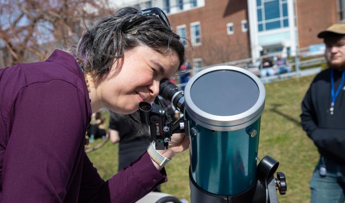 Professor of Integrated Science/Physics Andria Schwortz utilizing a telescope at the eclipse event. Professor of Integrated Science/Physics Andria Schwortz utilizing a telescope at the eclipse event.