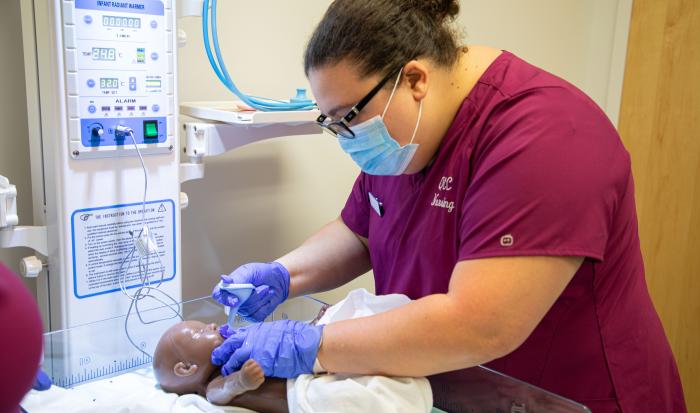 A QCC Nursing student using simulation equipment A QCC Nursing student using simulation equipment
