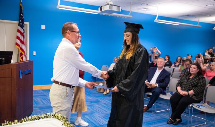 HSE/GED graduate Maria Snell receives a handshake from ACLC Case Manager Richard Nevalsky. HSE/GED graduate Maria Snell receives a handshake from ACLC Case Manager Richard Nevalsky.
