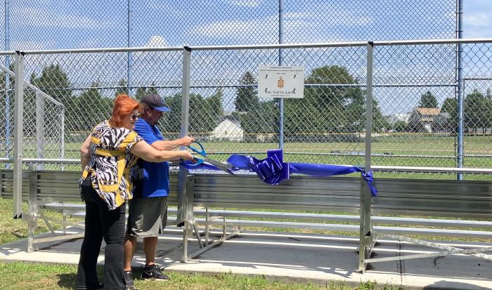 Former PTK President Kimberly Lindsey and Men's Baseball Coach Corey Coleman at the ribbon cutting for the new bleachers donated by PTK. Former PTK President Kimberly Lindsey and Men's Baseball Coach Corey Coleman at the ribbon cutting for the new bleachers donated by PTK.