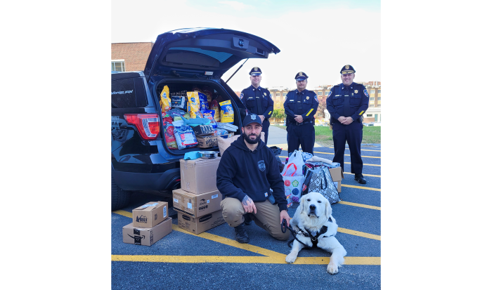 (front) Campus Police Officer Nick Yacuzzi with Community Resource Dog Siggy and (back, from left) Deputy Chief of Police Operations Mike Vigeant, Deputy Chief of Administration Reynaldo Rodriguez and Chief of Police Stephen DiGiovanni with a truckload of supplies for pets of hurricane victims. (front) Campus Police Officer Nick Yacuzzi with Community Resource Dog Siggy and (back, from left) Deputy Chief of Police Operations Mike Vigeant, Deputy Chief of Administration Reynaldo Rodriguez and Chief of Police Stephen DiGiovanni with a truckload of supplies for pets of hurricane victims.
