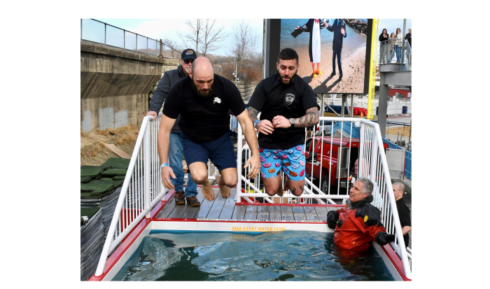 Community Resource Officer Nick Yacuzzi takes the Polar Plunge with a friend. Community Resource Officer Nick Yacuzzi takes the Polar Plunge with a friend.