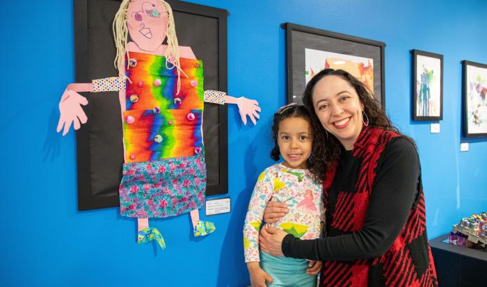 An artist and their relative with a fine work of art. An artist and their relative with a fine work of art.
