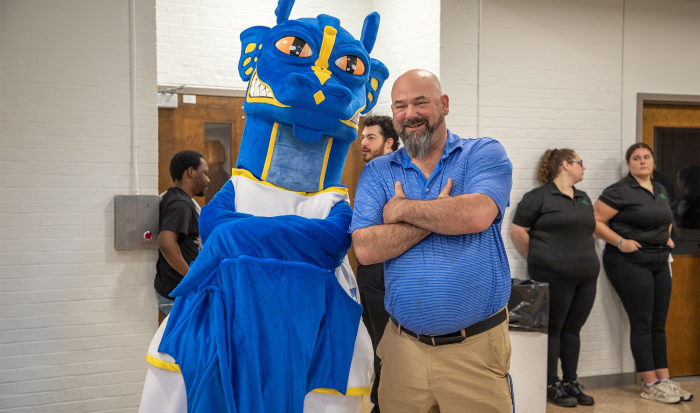 QCC student athlete Paul Landry hangs with the Wyvern at this year's athletic ceremony.