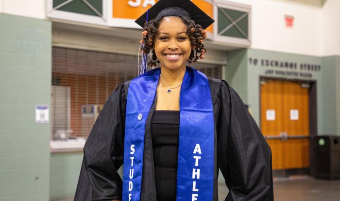 A student athlete graduate at QCC's 60th commencement ceremony.