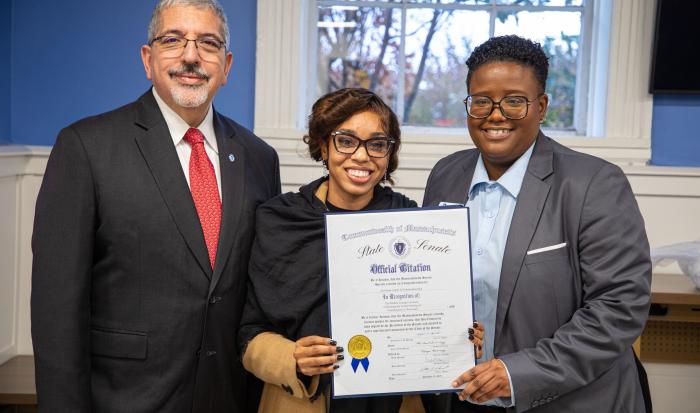 QCC President Dr. Luis Pedraja (left) and Director of the Auxilium Center for Entrepreneurship Rocky Knight (right) accepting a state citation from Kayanna James, district director for Senator Robyn Kennedy 