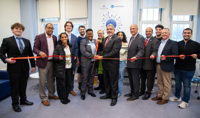 Director of the Auxilium Center for Entrepreneurship at QCC Rocky Knight and QCC President Dr. Luis Pedraja (center) cutting the ribbon with local officials, QCC trustees and QCC students.