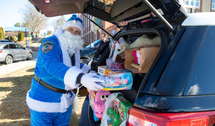 Blue Santa is at it again, preparing gifts for QCC families at Stuff A Cruiser.