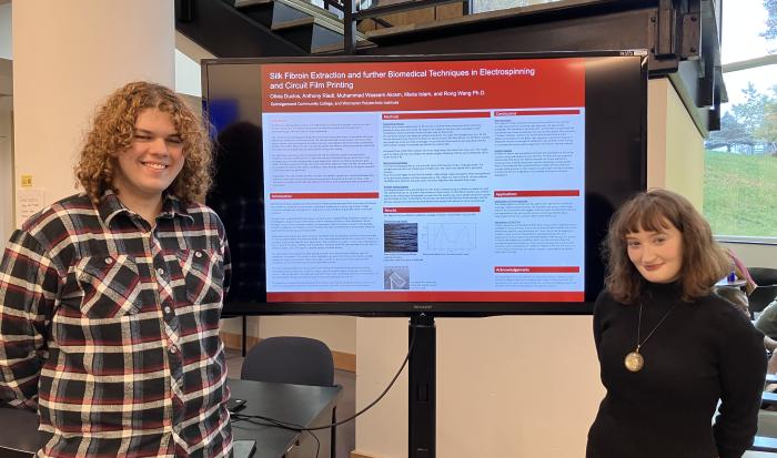 STEM students Anthony Riedl (left) and Olivia Duclos present their research. 