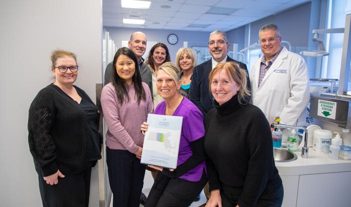 Front (from left): The Health Foundation Director of Finance and Administration Michelle L. Ewing, The Health Foundation President and CEO Amie Shei, Dental Clinic Operations & Facilities Mgr. Rene Cummings, and Prof. of Dental Assisting-Hygiene Jennifer McKeon. Back (from left) The Health Foundation Grants and Operations Manager Daniel P. Germain, Dir. of Grants Development Nicole Heldenbergh, Dental Hygiene Coordinator Jane Gauthier, QCC President Dr. Luis Pedraja, and Dean of Healthcare Pat Schmohl