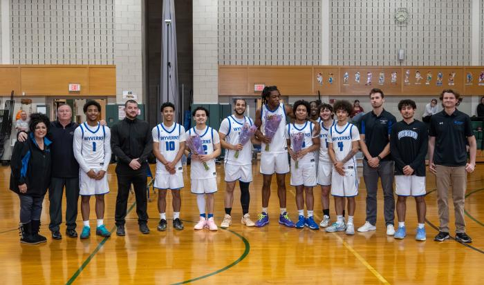 Celebrating sophomores on the men's basketball team (with flowers, from left) Xavier Garcia, Ahmed Elbahlawan, Jahi Ashby, and Jaeden Echevarria
