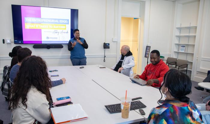 Rocky Knight (standing), director of the Auxilium Center for Entrepreneurship, during a presentation at the Center.