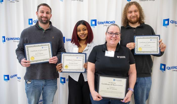 QCC IT co-op students (from left) Kyle Pagnoni, Doriane Lienou, and Luke Curtis with Associate Director of IT Services Monica McMullan (second from right)