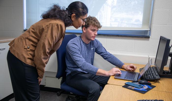 Professor of Computer Information Systems Gargi Chug helps a student.