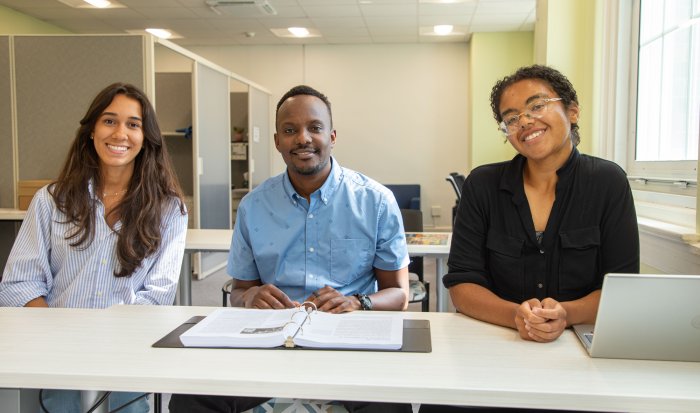 (From left) student Juliana Rosas, Project Director of TRIO Programs Peter Munene, and student Olivia Madore
