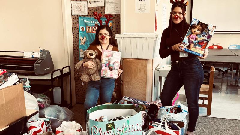 From left: Southbridge Elementary School liaisons Karina Alvarado and Selena Robles with donations from QCC's Human Services Clu