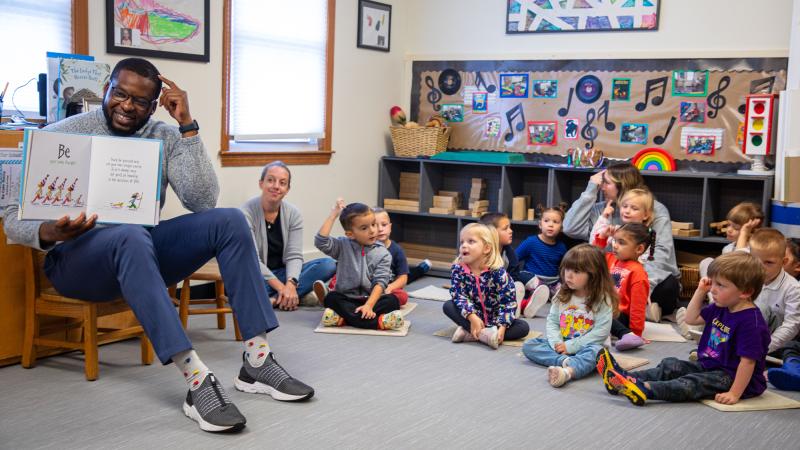 Executive Director of Diversity, Equity & Inclusion Kevin Lovaincy reads to children.