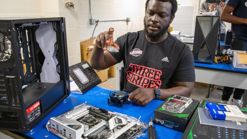 A qcc student taking apart a computer