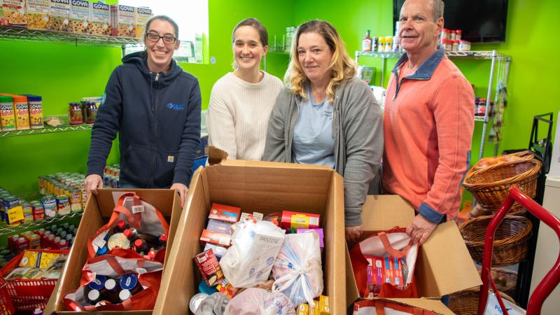 From left: Jodie Bastarache from Elm Electrical, food pantry staff members Julia Rooney and Cheryl Marrino, and Mark Laverdure, who drives the truck for the food pantry