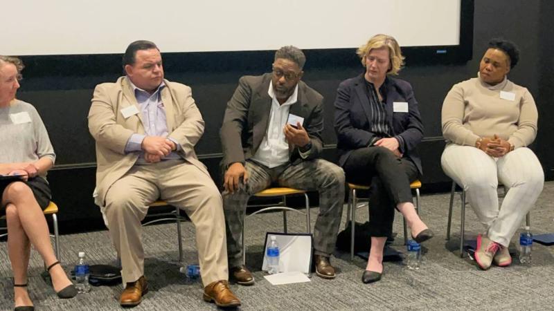Director of Community Engagement Sean Harris (center) speaks at the Housing Justice Summit