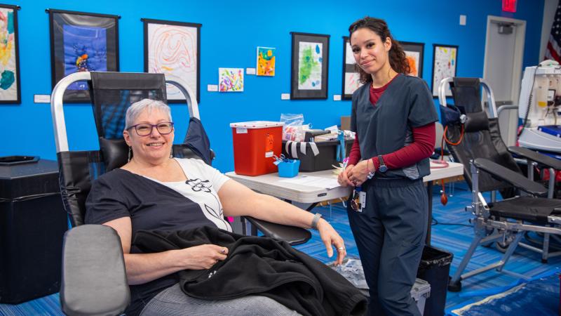 Assistant Director of Operations for External Affairs Shirley Dempsey (left) donating blood.