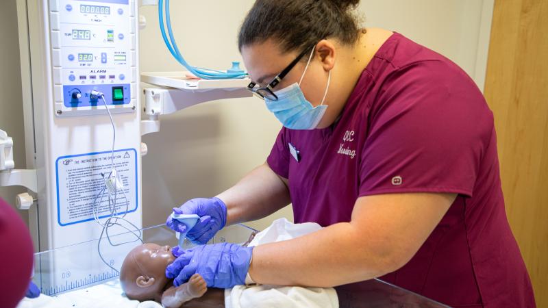 A QCC Nursing student using simulation equipment