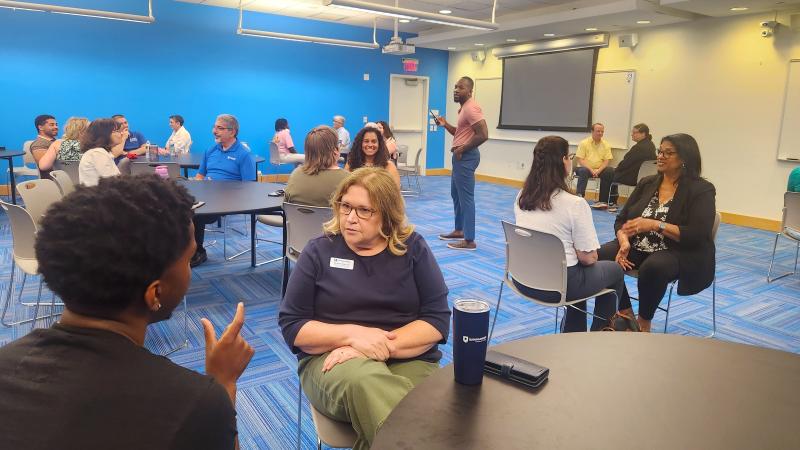 chris bijoux leads the audience through a conversation activity on Juneteenth.