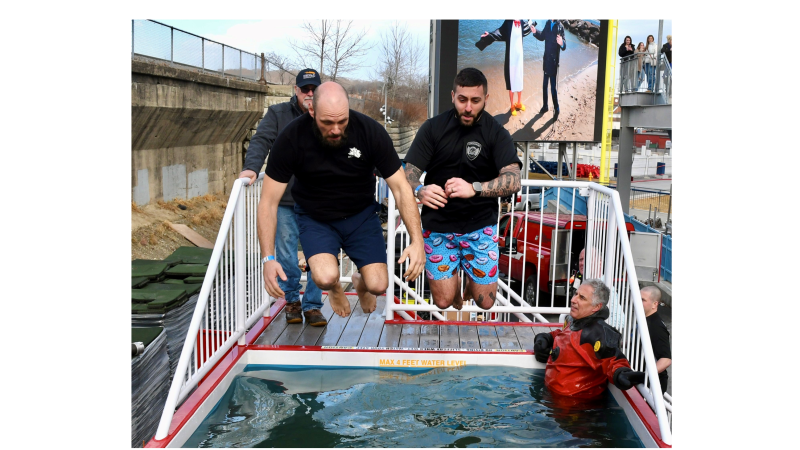 Community Resource Officer Nick Yacuzzi takes the Polar Plunge with a friend.