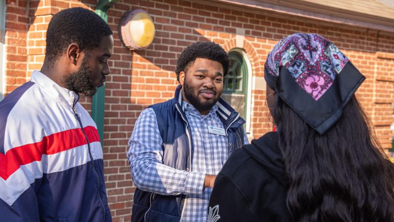 Director of Mentoring and Special Programs Kalan Lewis (center) at a mentoring event