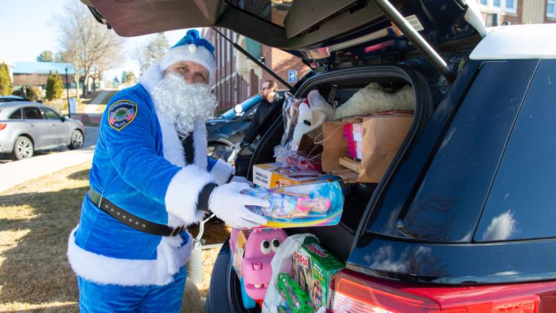 Blue Santa is at it again, preparing gifts for QCC families at Stuff A Cruiser.