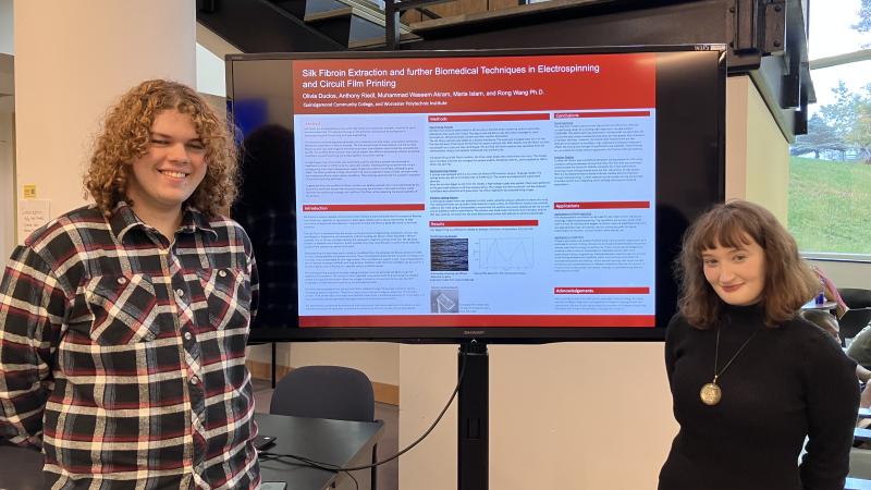 STEM students Anthony Riedl (left) and Olivia Duclos present their research. 