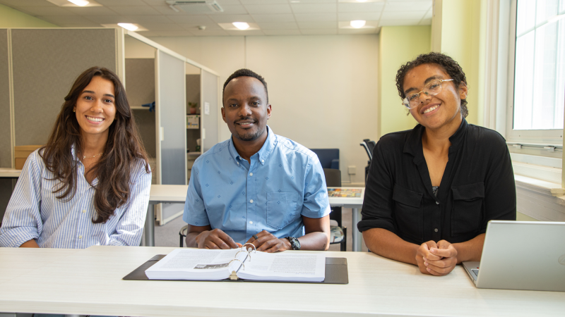 (From left) student Juliana Rosas, Project Director of TRIO Programs Peter Munene, and student Olivia Madore