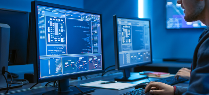 A student looks at a computer screen with complex statistics